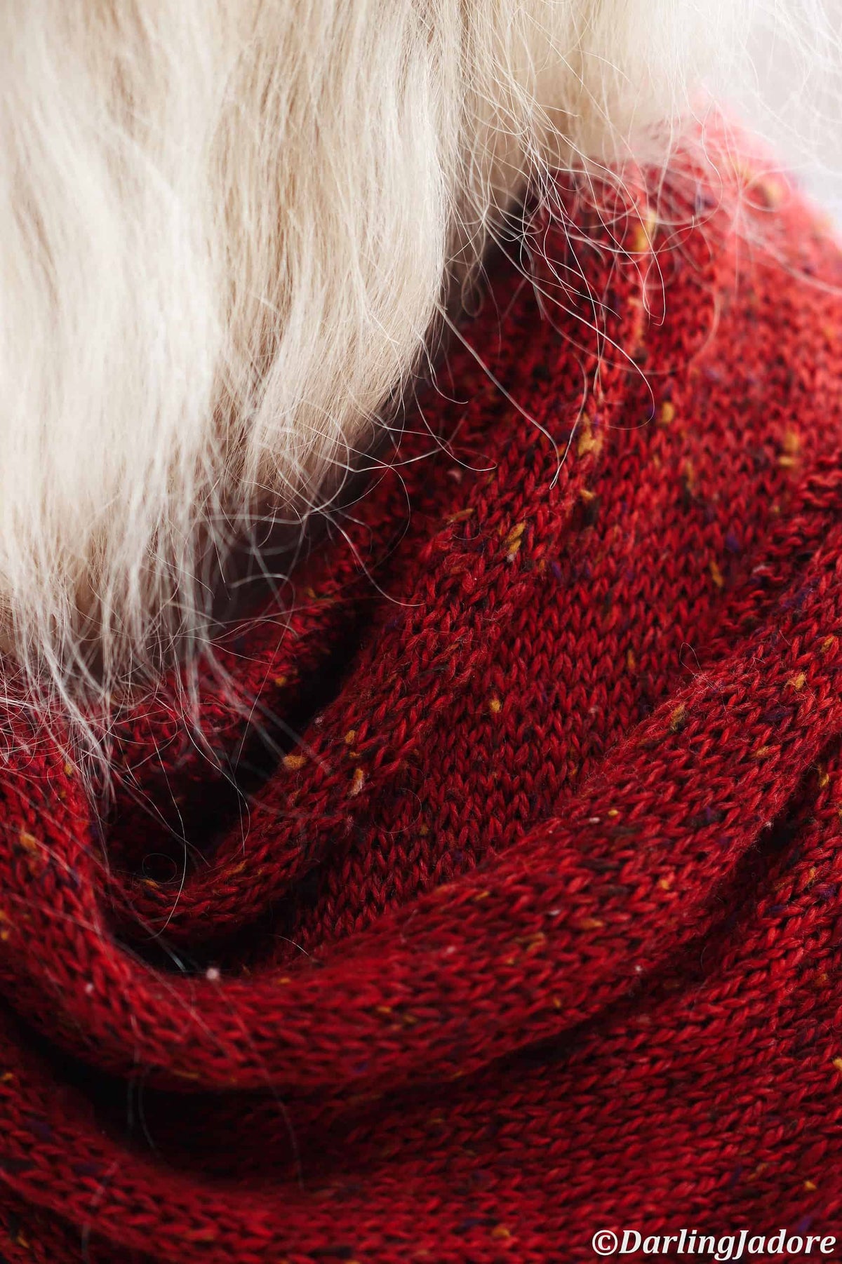 Red classic knit scarf draped elegantly - beginner friendly scarf knitting pattern