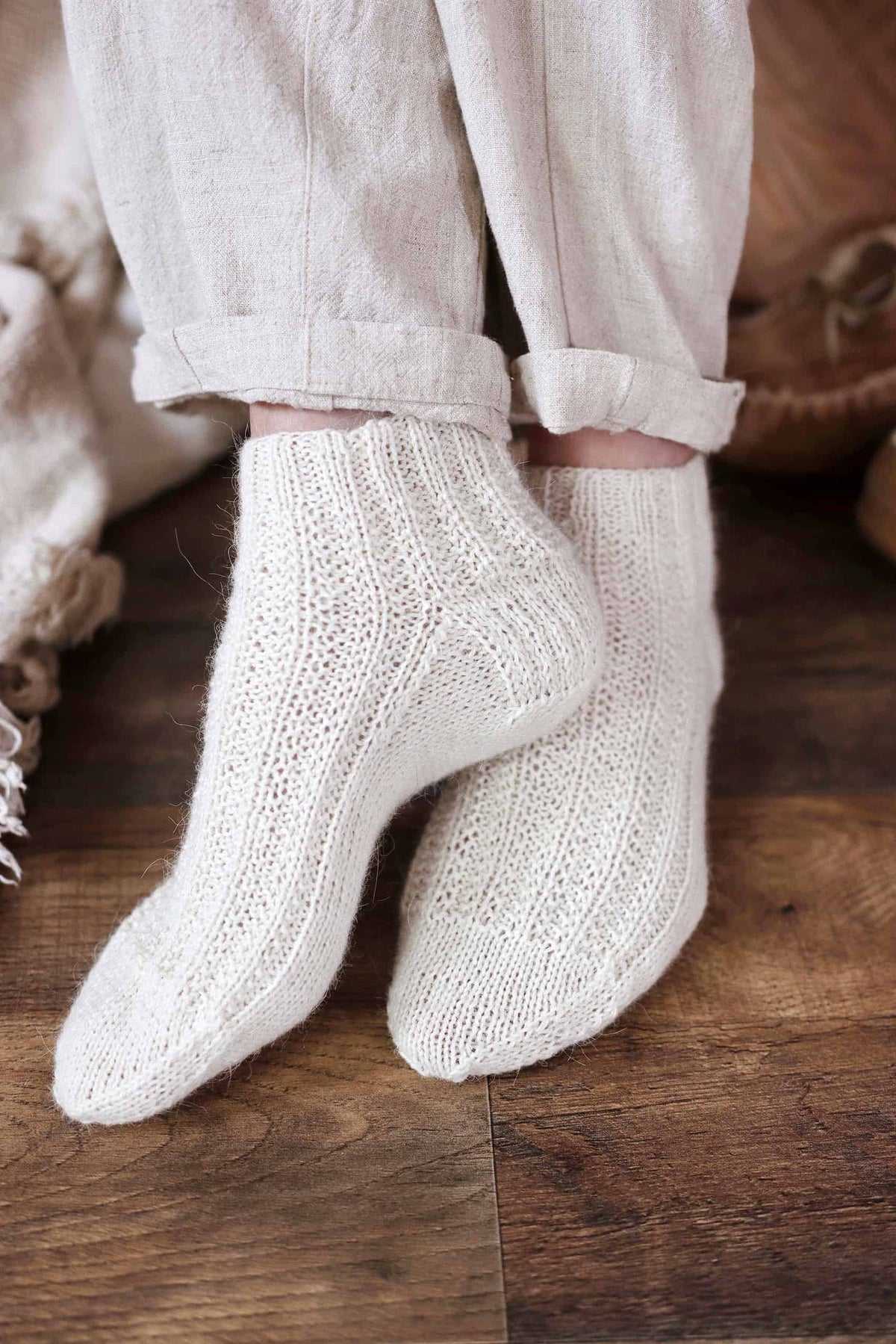 Beginner friendly ankle socks knitting pattern styled on model