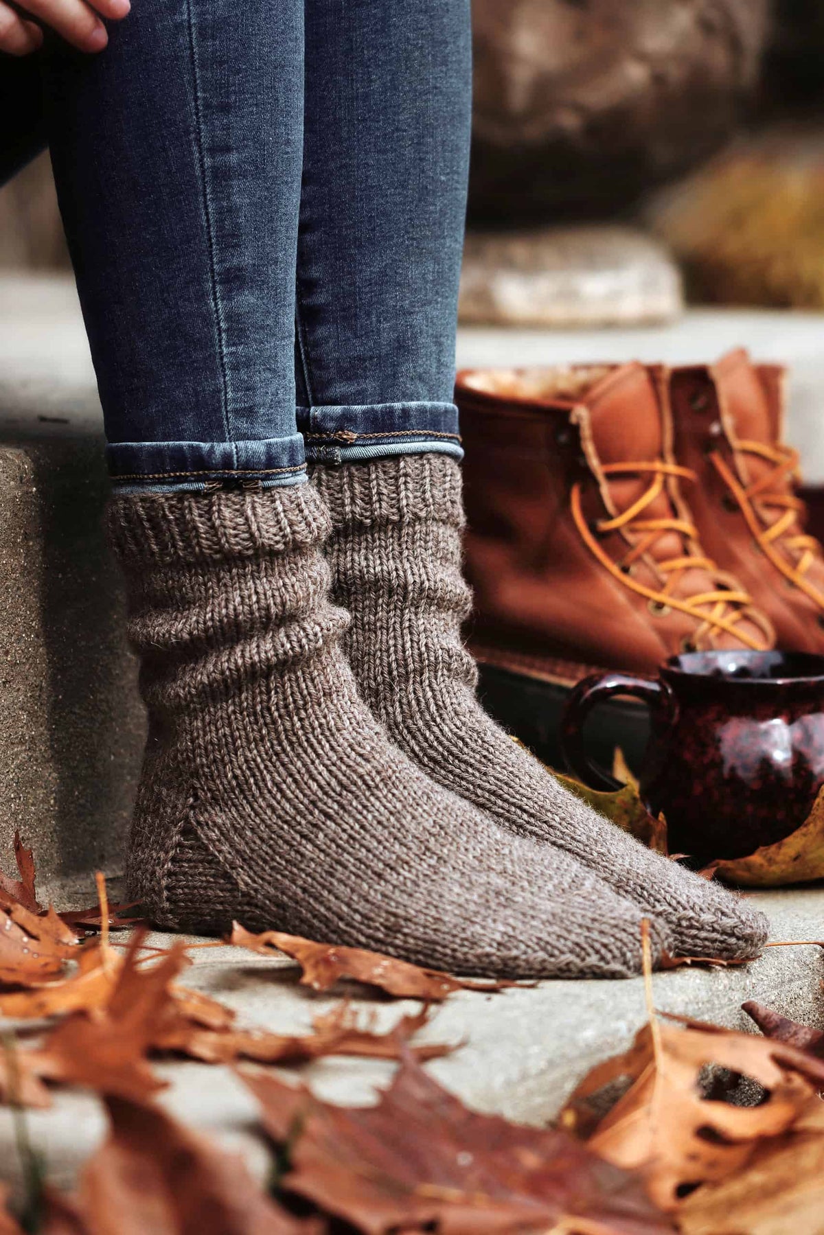 Worsted weight beginner socks knitting pattern styled with boots