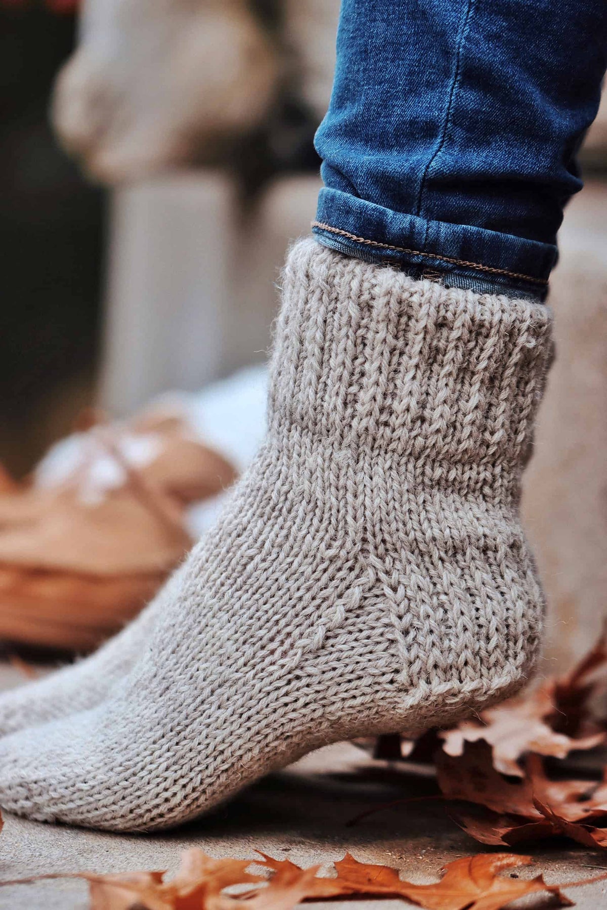 Close-up of beginner-friendly worsted socks knitting pattern showing textured cuff detail