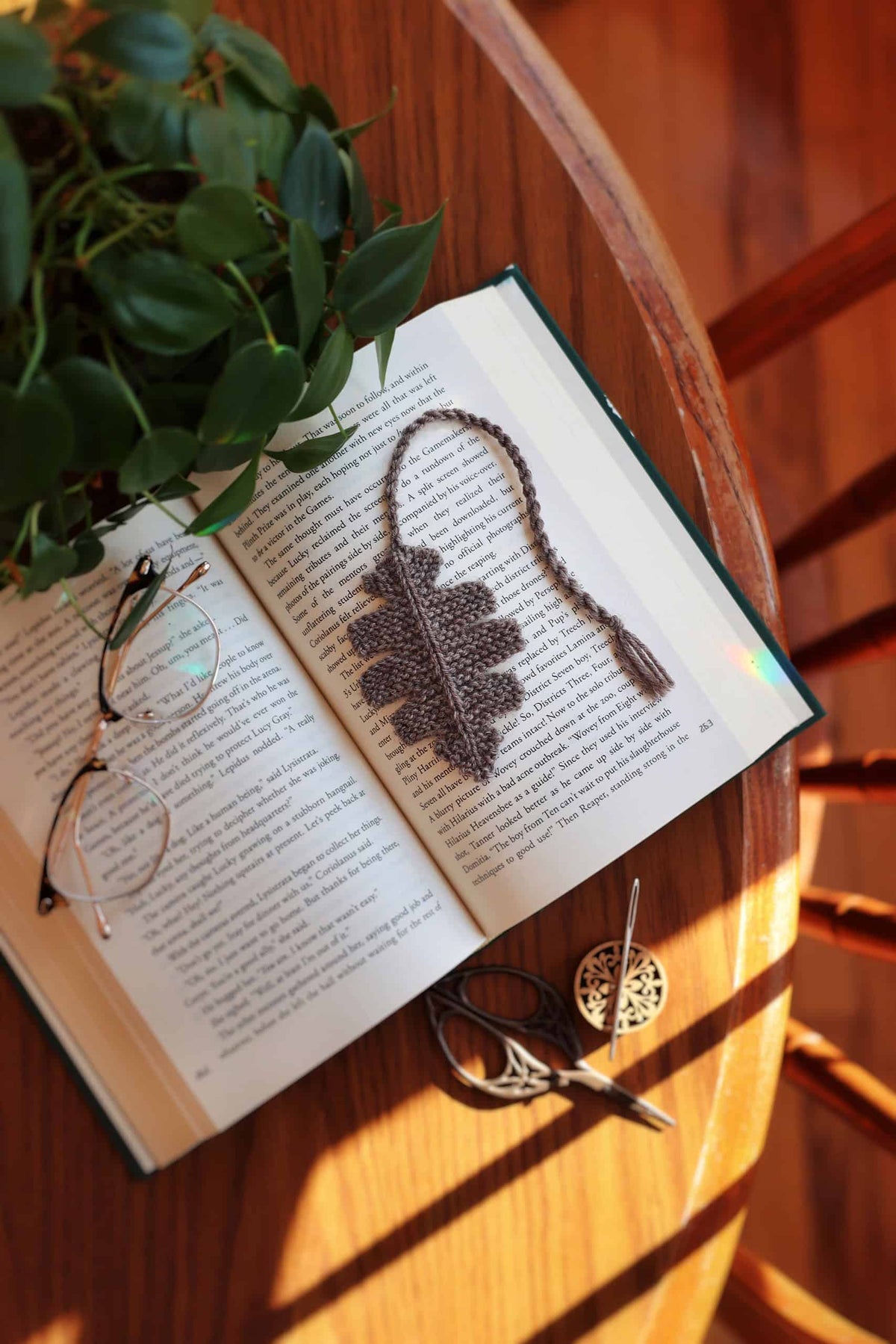 Oak leaf bookmark knitting pattern shown in book with natural lighting