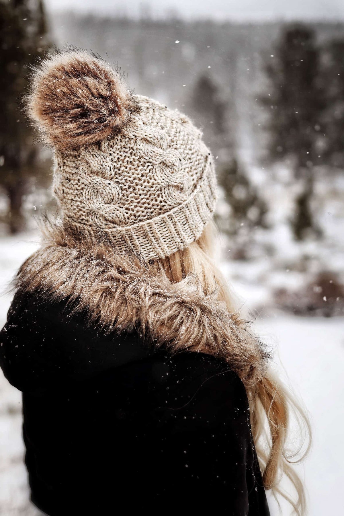 Side view of cable beanie knitting pattern with prominent textured cables and cozy fold-up brim