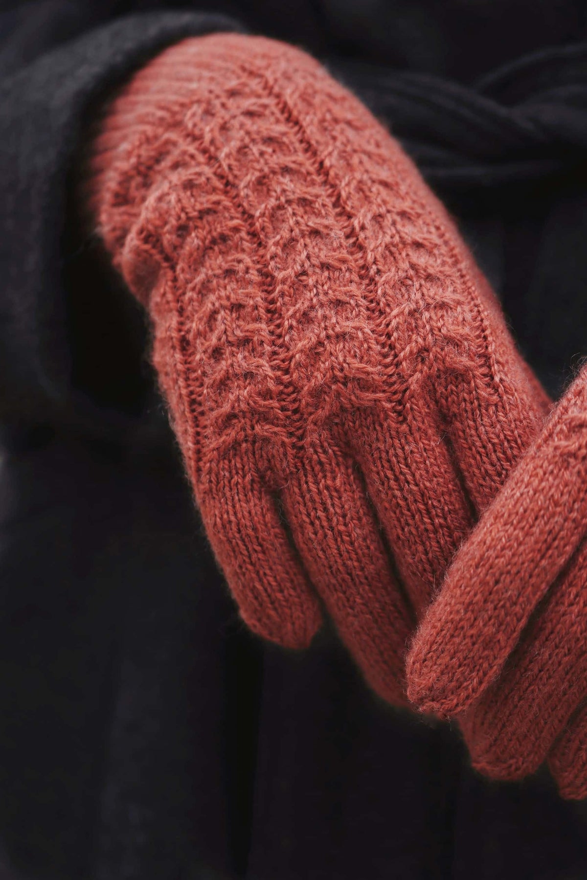 Cable knit gloves pattern in neutral tone showing sophisticated twisted cable detail