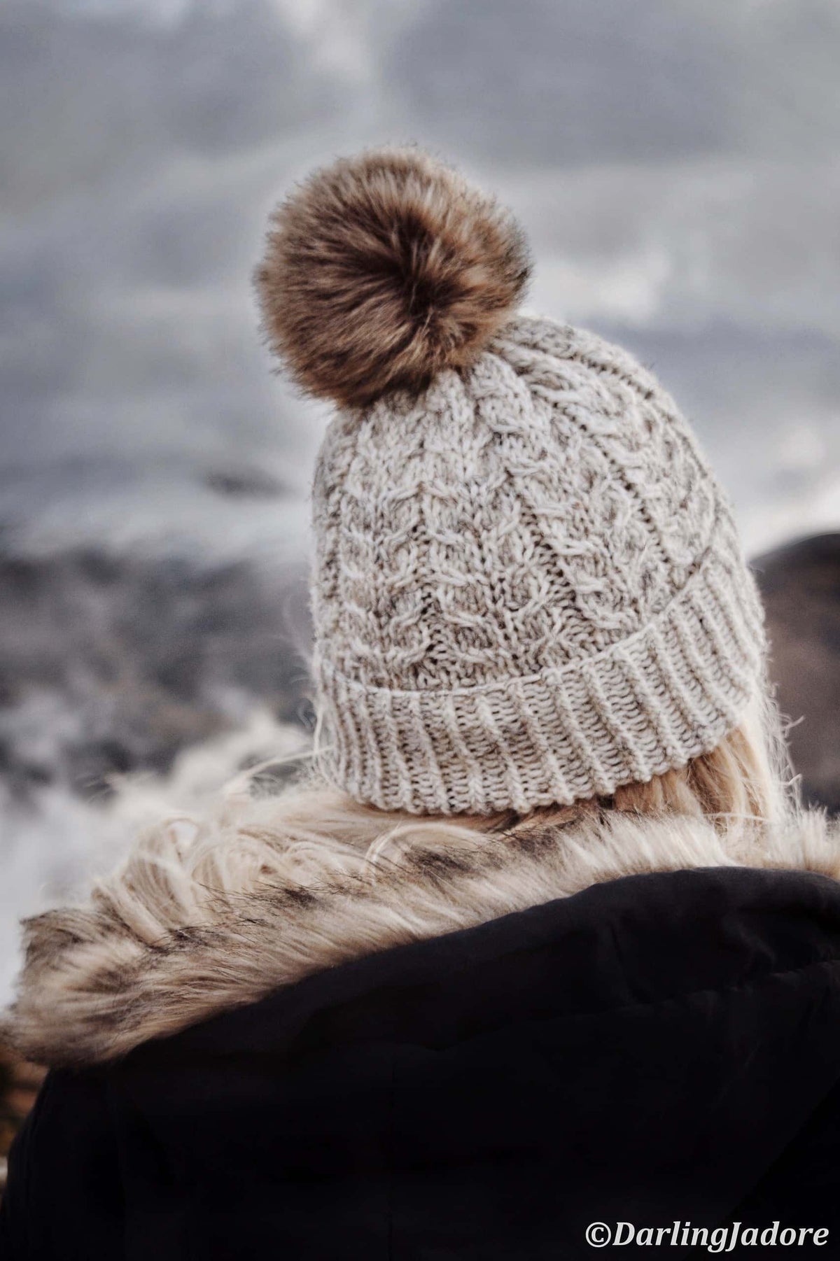 Detail of cable knit beanie pattern showing twisted vine-like cable texture and ribbing