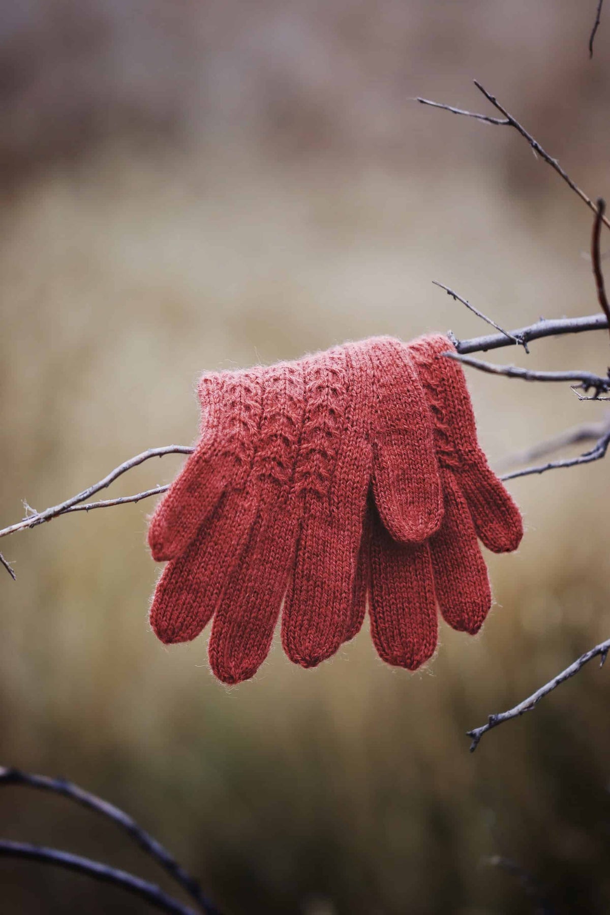 Juniper cable knit gloves knitting pattern in cream yarn with detailed cable texture