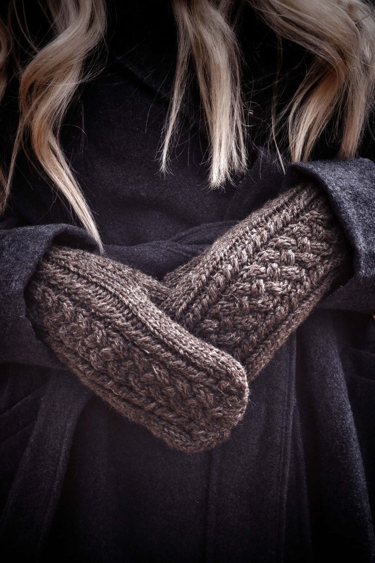 Hand-knit cable mittens pattern in luxurious cream yarn showing cozy texture