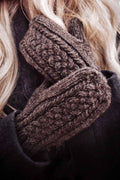Cable knit mittens pattern featuring woven-like braid detail in soft cream yarn