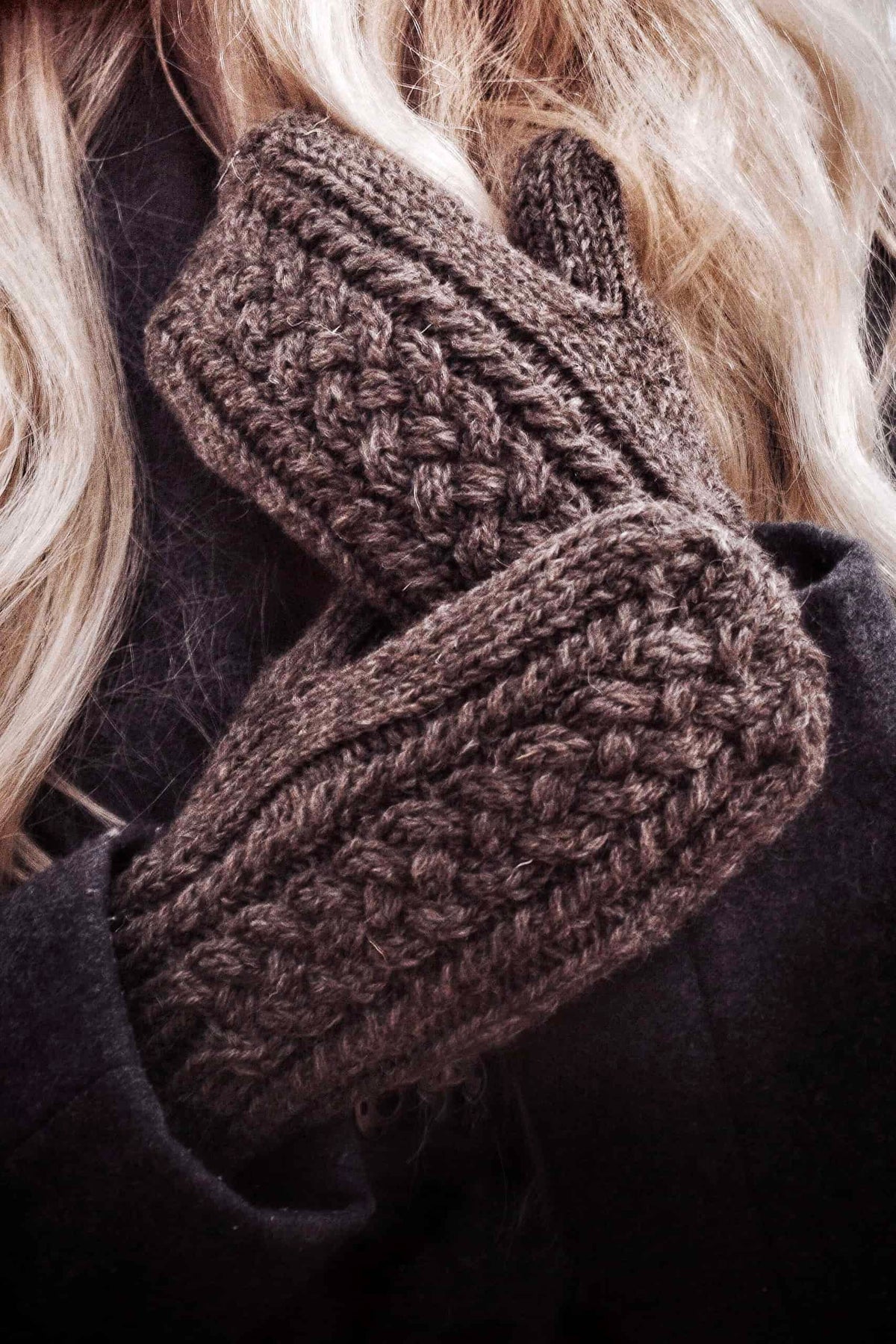 Cable knit mittens pattern featuring woven-like braid detail in soft cream yarn