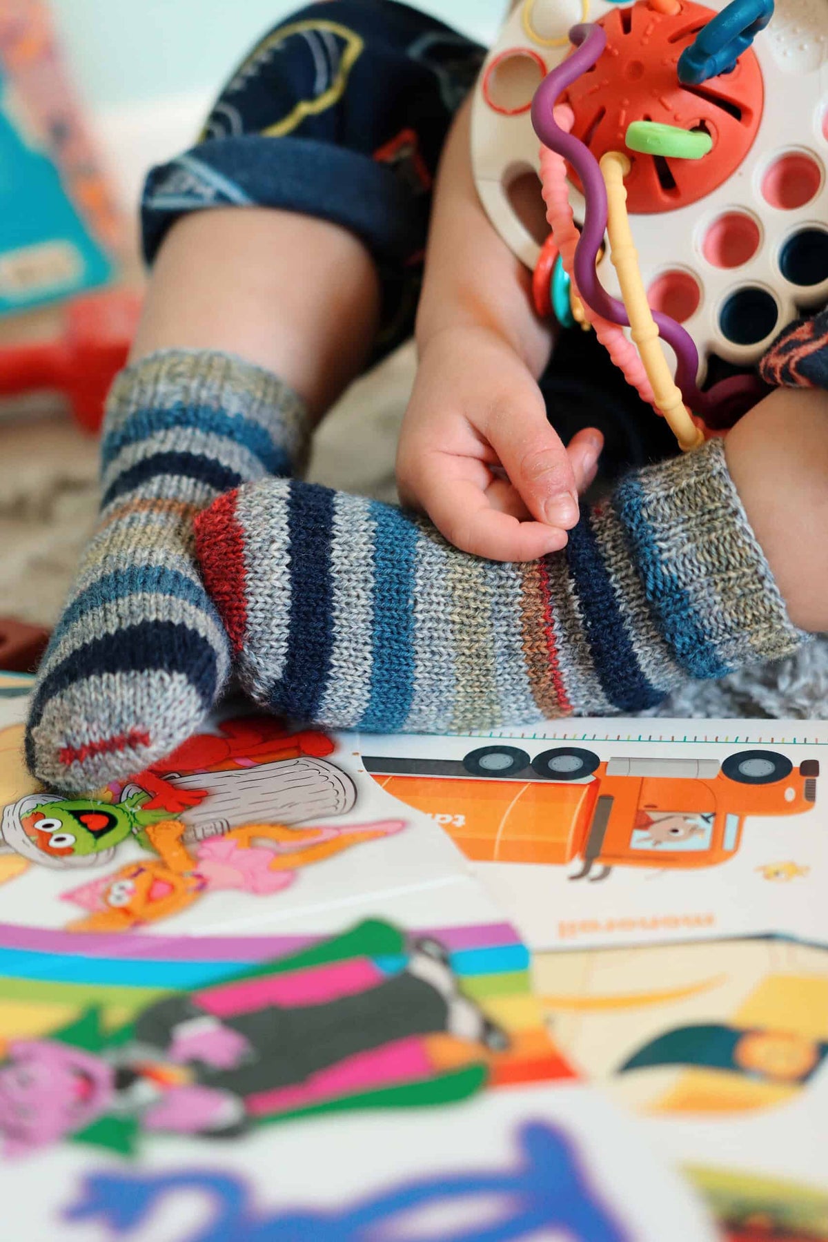Child wearing handknit colorblock socks from The Cuddle Socks knitting pattern by Darling Jadore