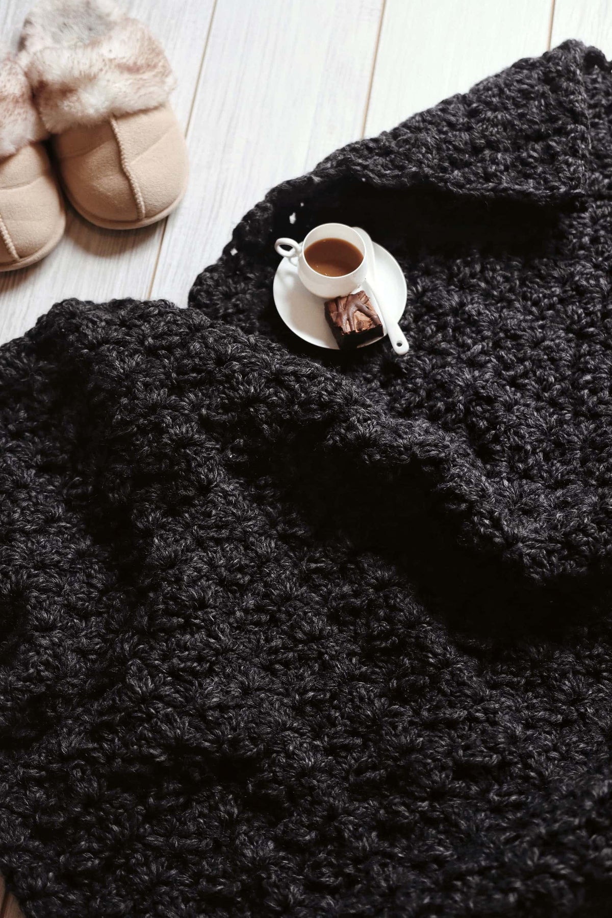 Super bulky crochet throw pattern with elegant scalloped texture in cream colored yarn