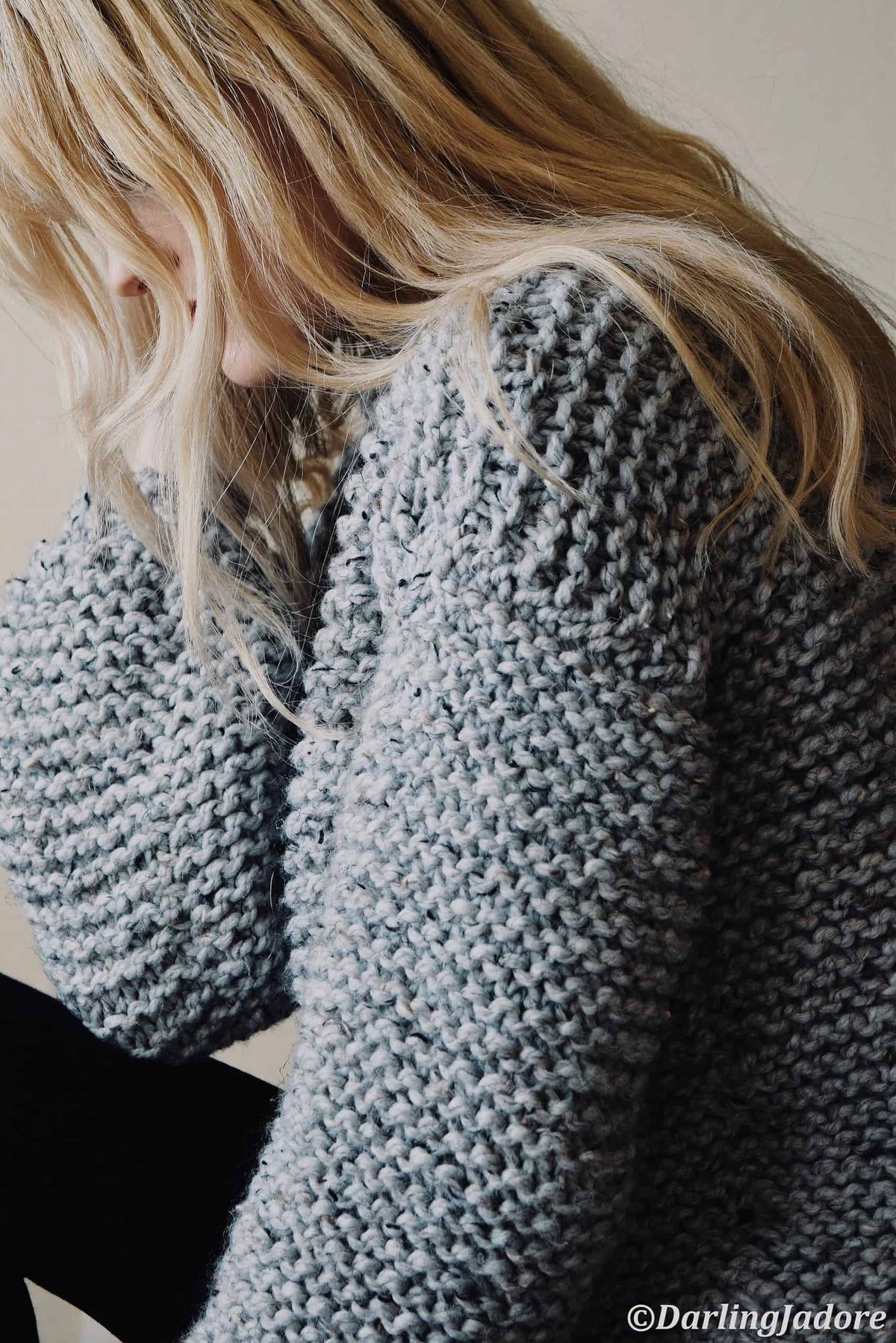 Woman wearing cozy chunky garter stitch Campfire Sweater in cream yarn, beginner sweater knitting pattern