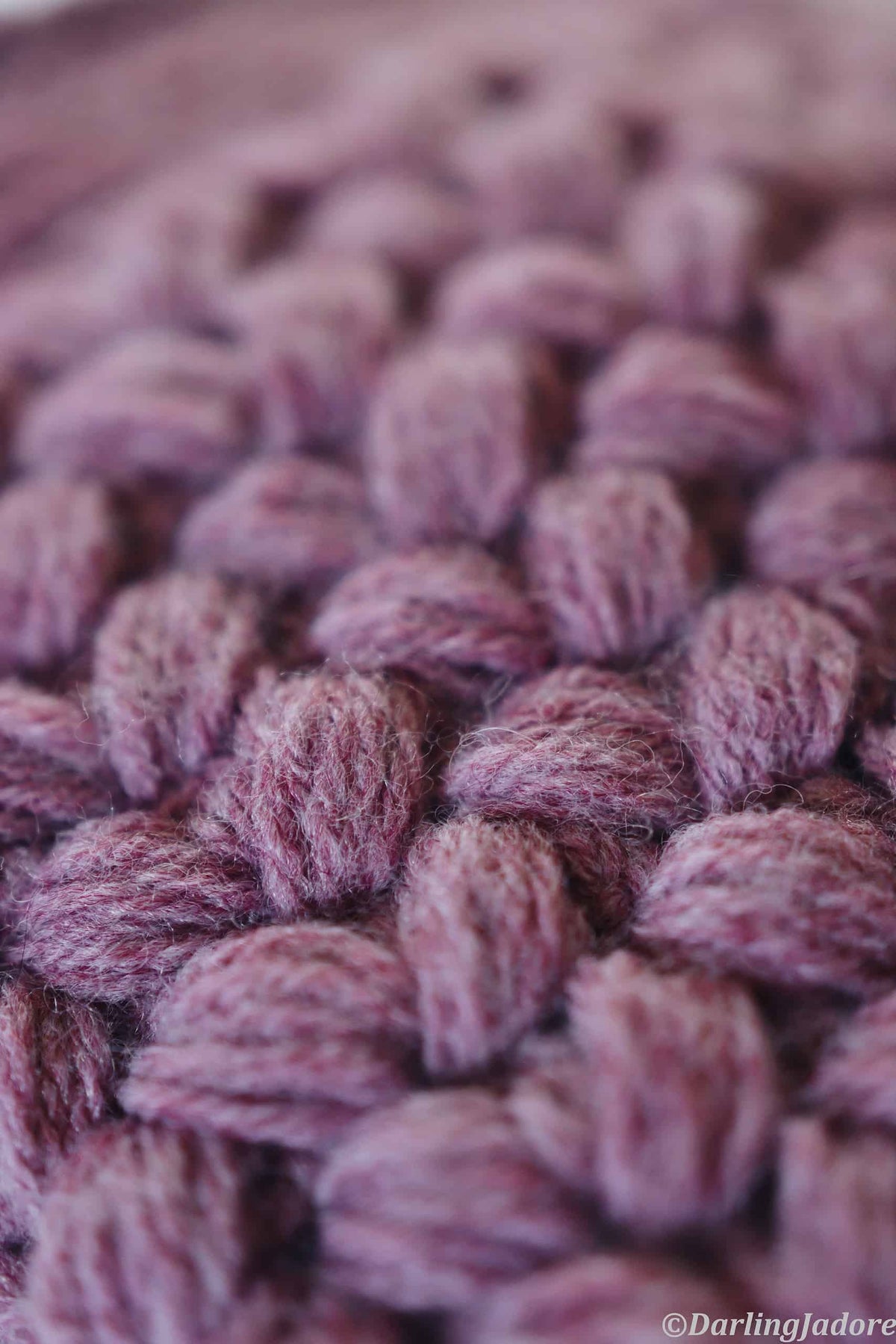Close-up of puffy textured stitches on handmade crochet clutch bag