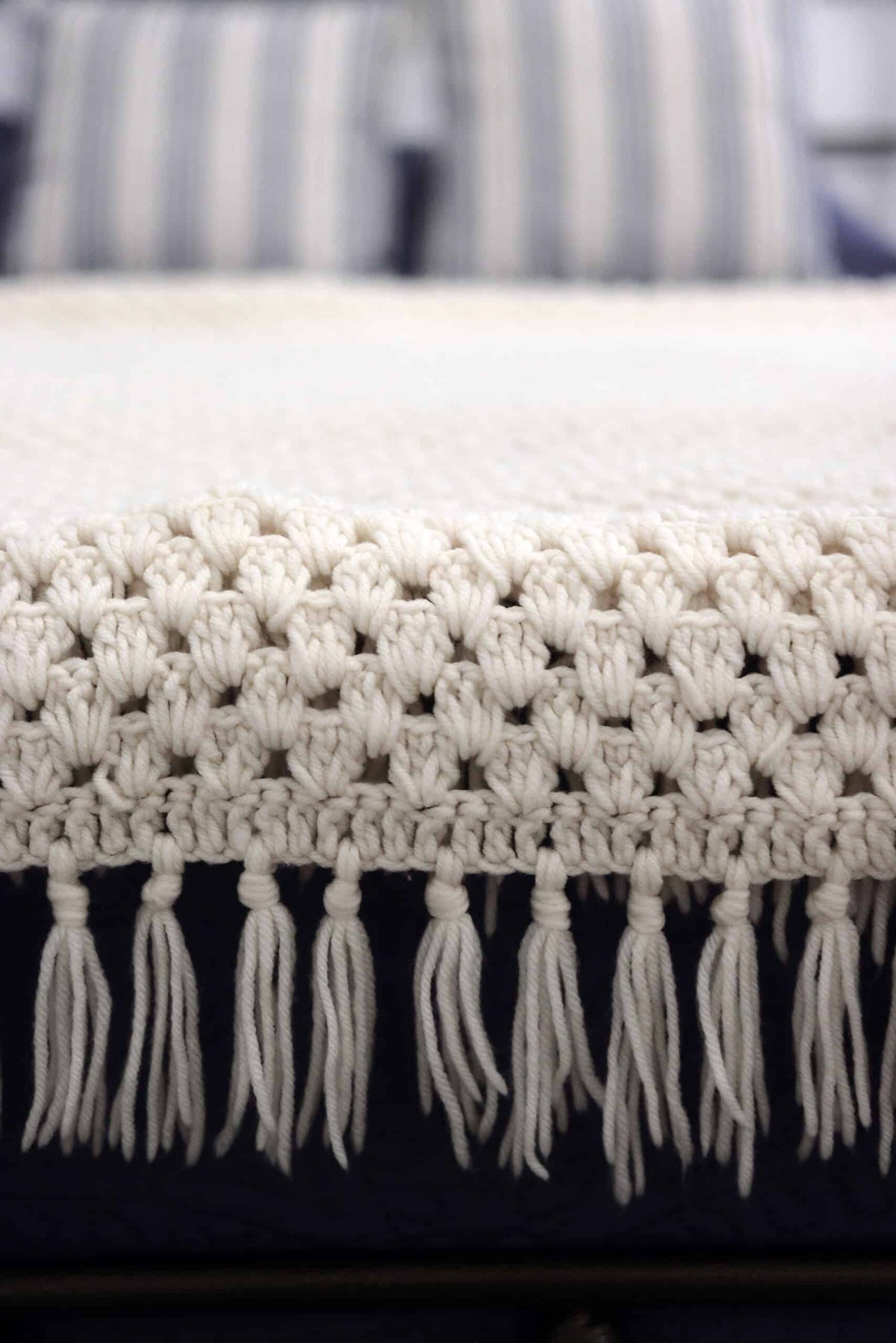 Easy crochet weighted blanket pattern - cozy Brookhaven Throw in neutral tones with tassel detail