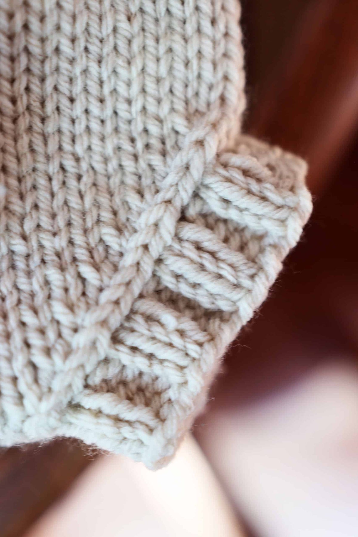 Baby wearing handknit cream bloomers and beanie set knitting pattern by Darling Jadore