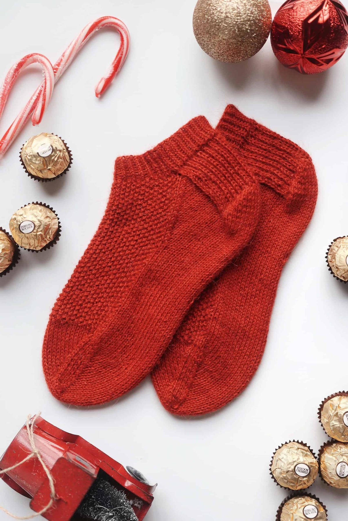 Easy beginner-friendly ankle socks knitting pattern in warm red yarn