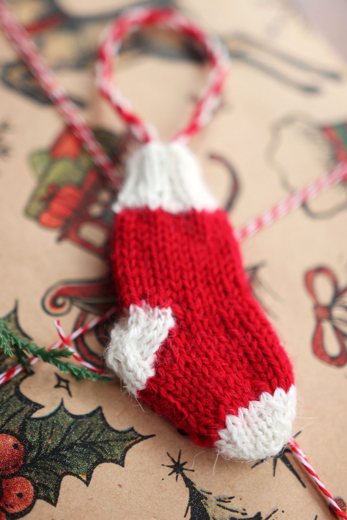 Easy beginner mini stocking knitting pattern shown in cream yarn with classic ribbed cuff detail