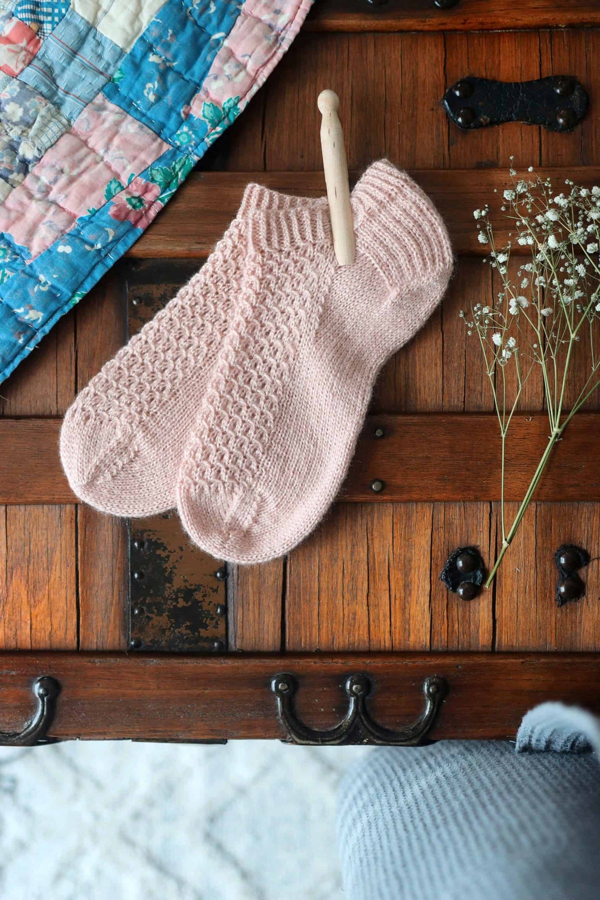 Lace knit ankle socks pattern showing elegant eyelet swirls and texture