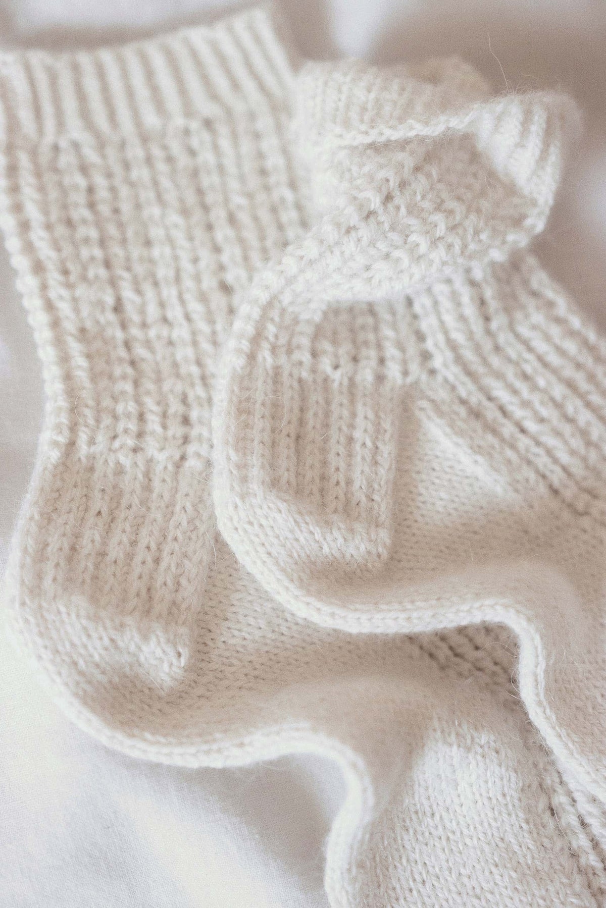 Full view of handknit Snowfield lace socks showing classic structure and pretty lace details
