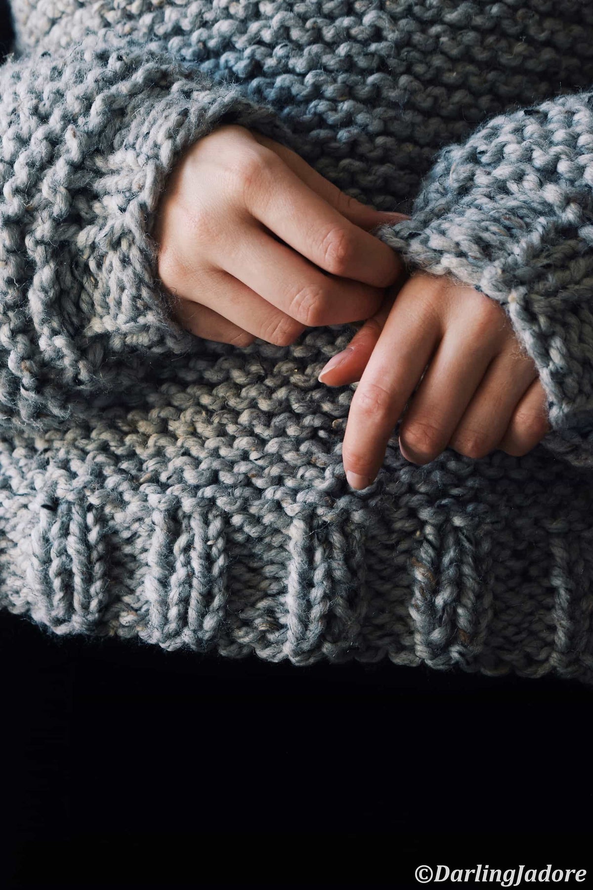 Close-up of easy beginner-friendly Campfire Sweater knitting pattern in bulky cream yarn
