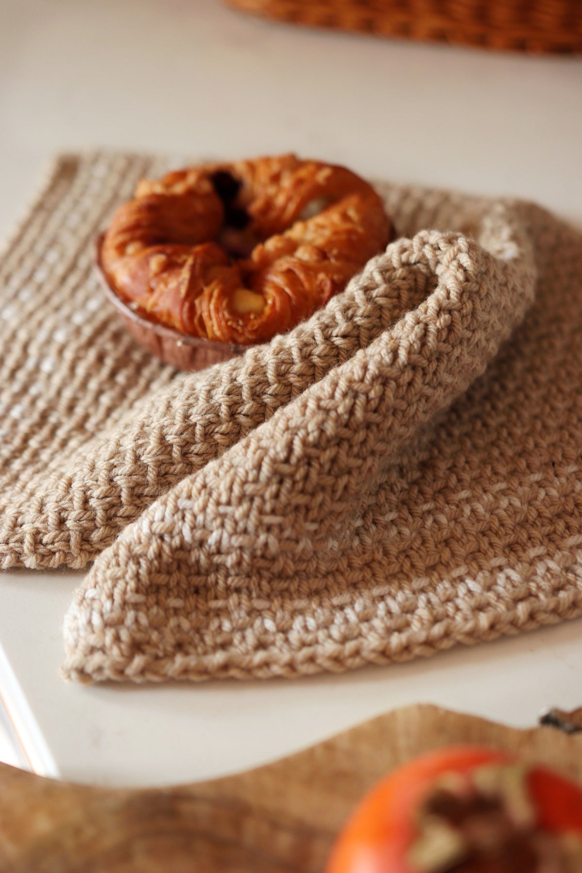 Cream knitted kitchen towel with textured stitch pattern hanging in farmhouse kitchen - Homestead Towel pattern