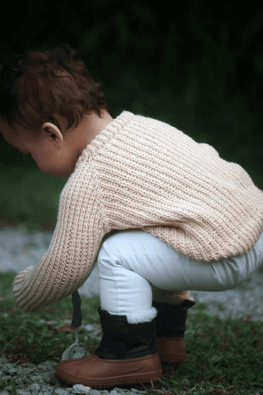 Timeless baby sweater knitting pattern with squishy fisherman rib stitch