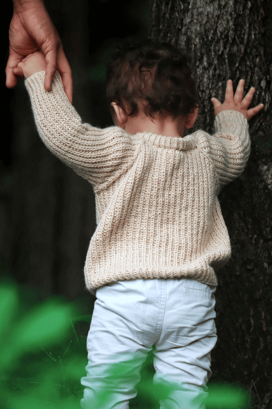 Fisherman rib baby sweater knitting pattern detail showing plush texture