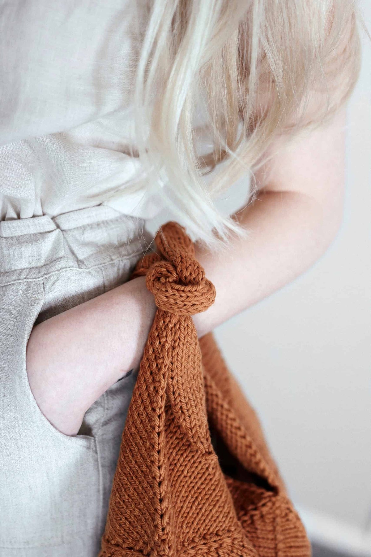Close-up of bento purse knitting pattern showing origami-style seaming detail