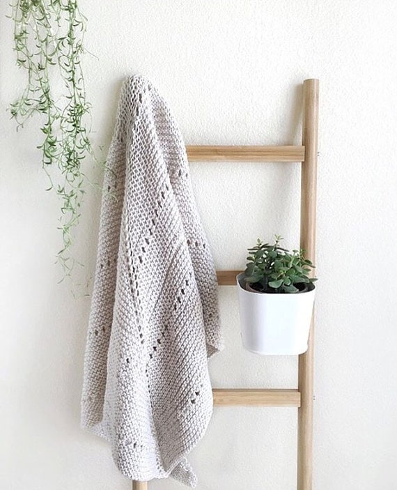 Detail of eyelet border on cream knit triangle shawl knitting pattern