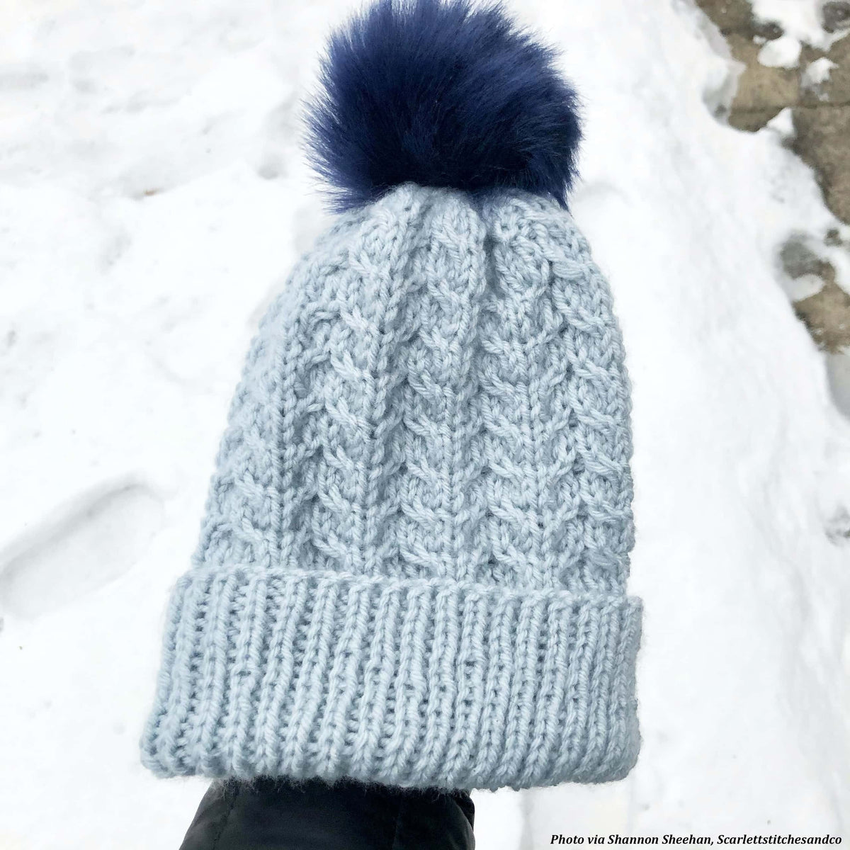 Model wearing Lakewood cable knit beanie pattern in neutral tone with classic ribbed brim