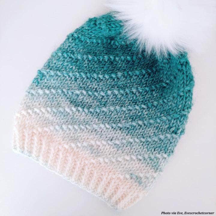 Flat lay of Iris beanie knitting pattern showing swirl design and construction