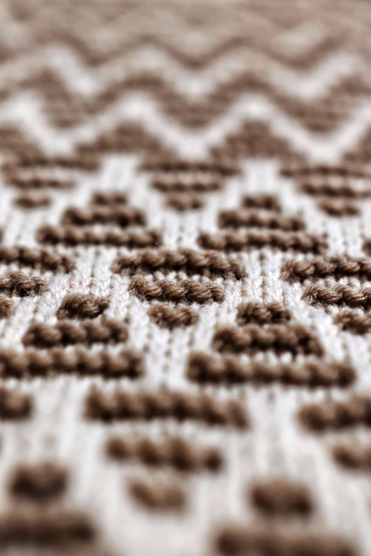 Hand knit kitchen towel with textured ridges and alternating colors displayed as kitchen décor accent