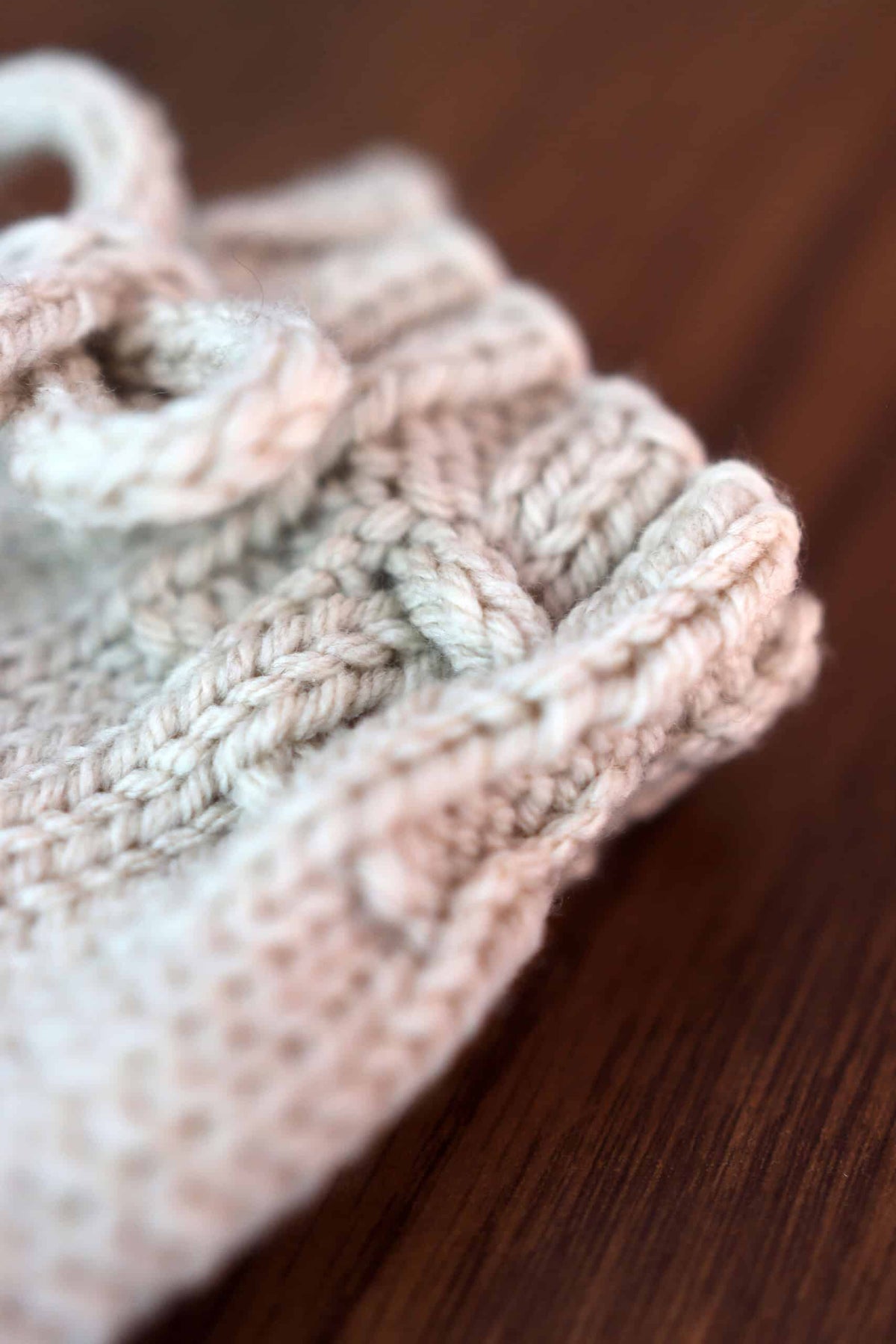 Close up of knit baby bloomers with textured stitch detail and elastic waistband