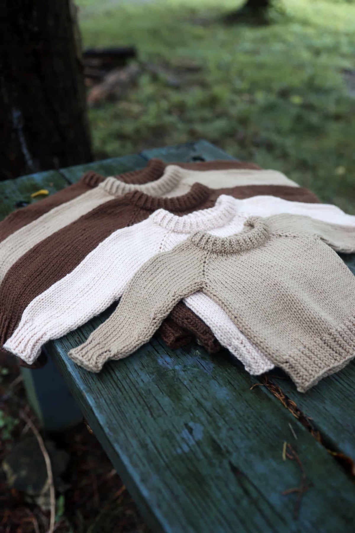 Cream colored hand knit baby raglan sweater with double-thick neck detail