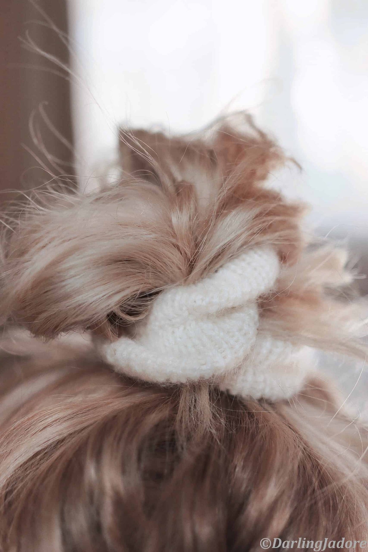 Handmade knit scrunchie pattern detail showing soft stretchy texture and refined finish