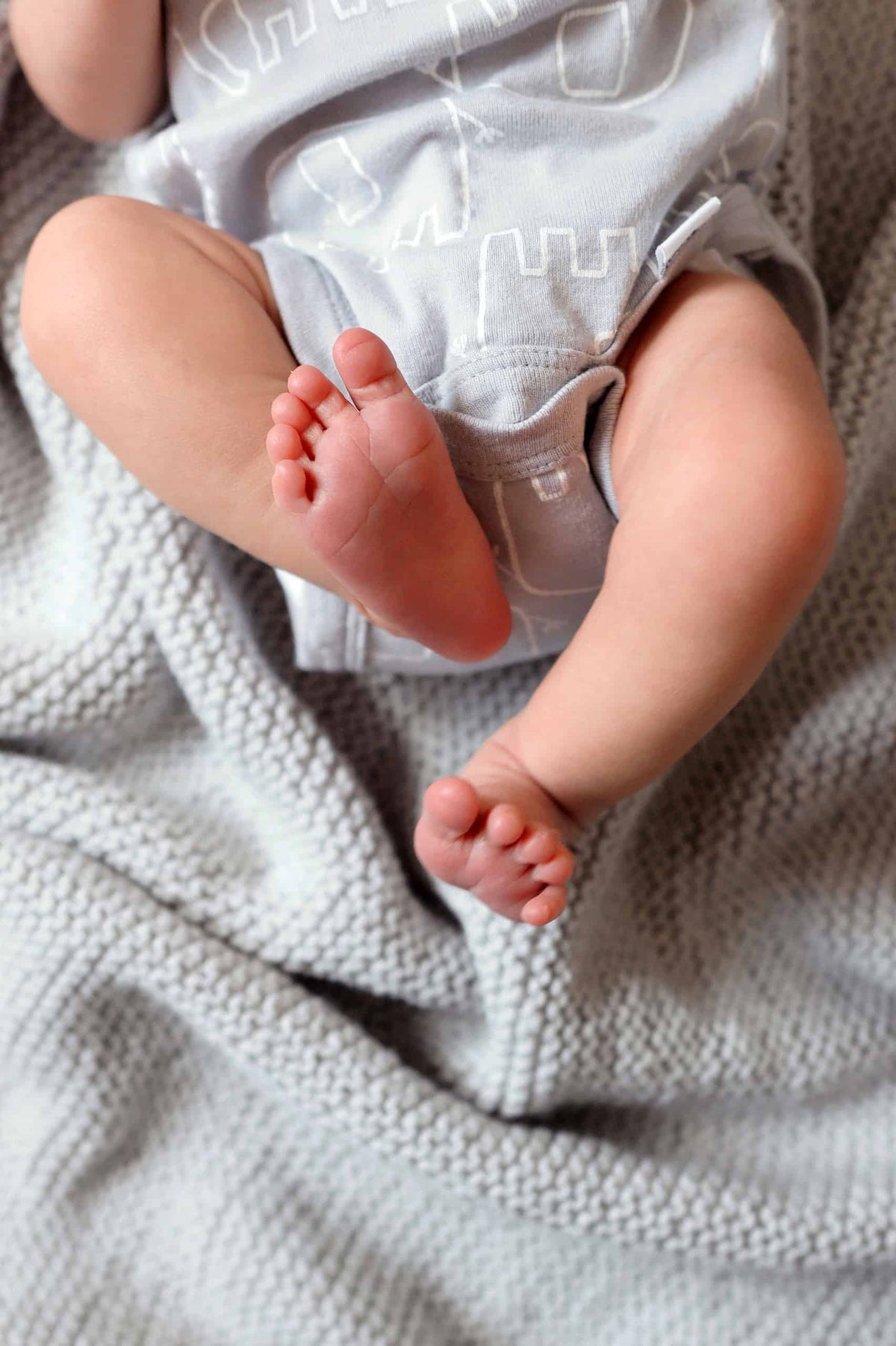Close up of classic baby blanket garter stitch texture and delicate eyelet border detail
