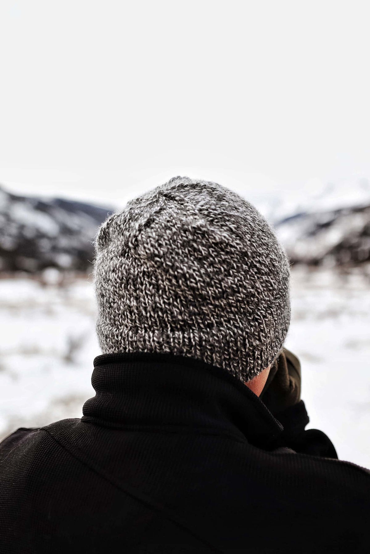 Gray double brim beanie knitting pattern for men modeled outdoors in winter