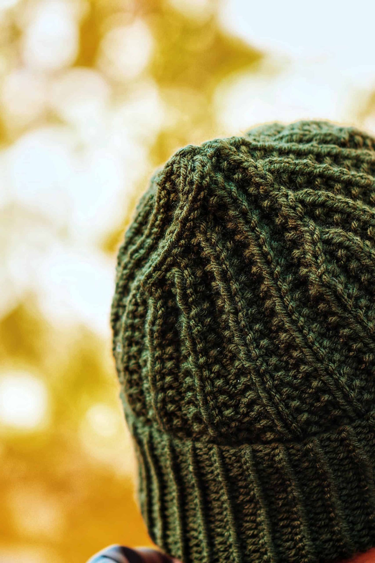 Side view of classic mens toque knitting pattern showing stretchy ribbed texture and comfortable fit