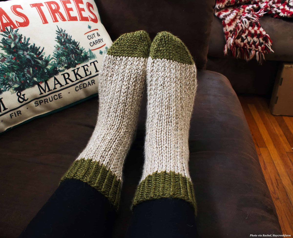The Mountain Socks knitting pattern flat lay showing finished cream colored boot socks