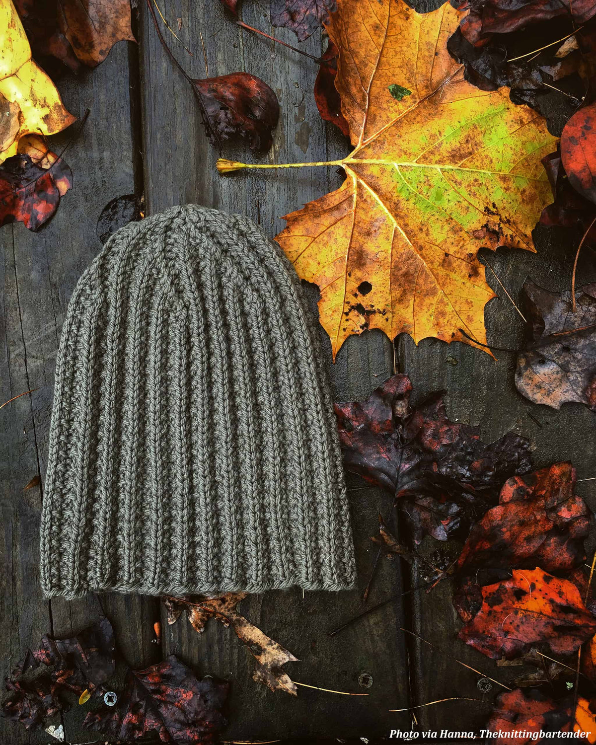 The Oakwood mens toque knitting pattern styled on model outdoors in natural light