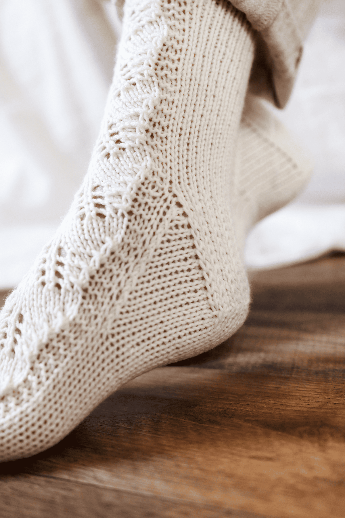 The Juniper Socks intermediate lace knitting pattern cover by Darling Jadore