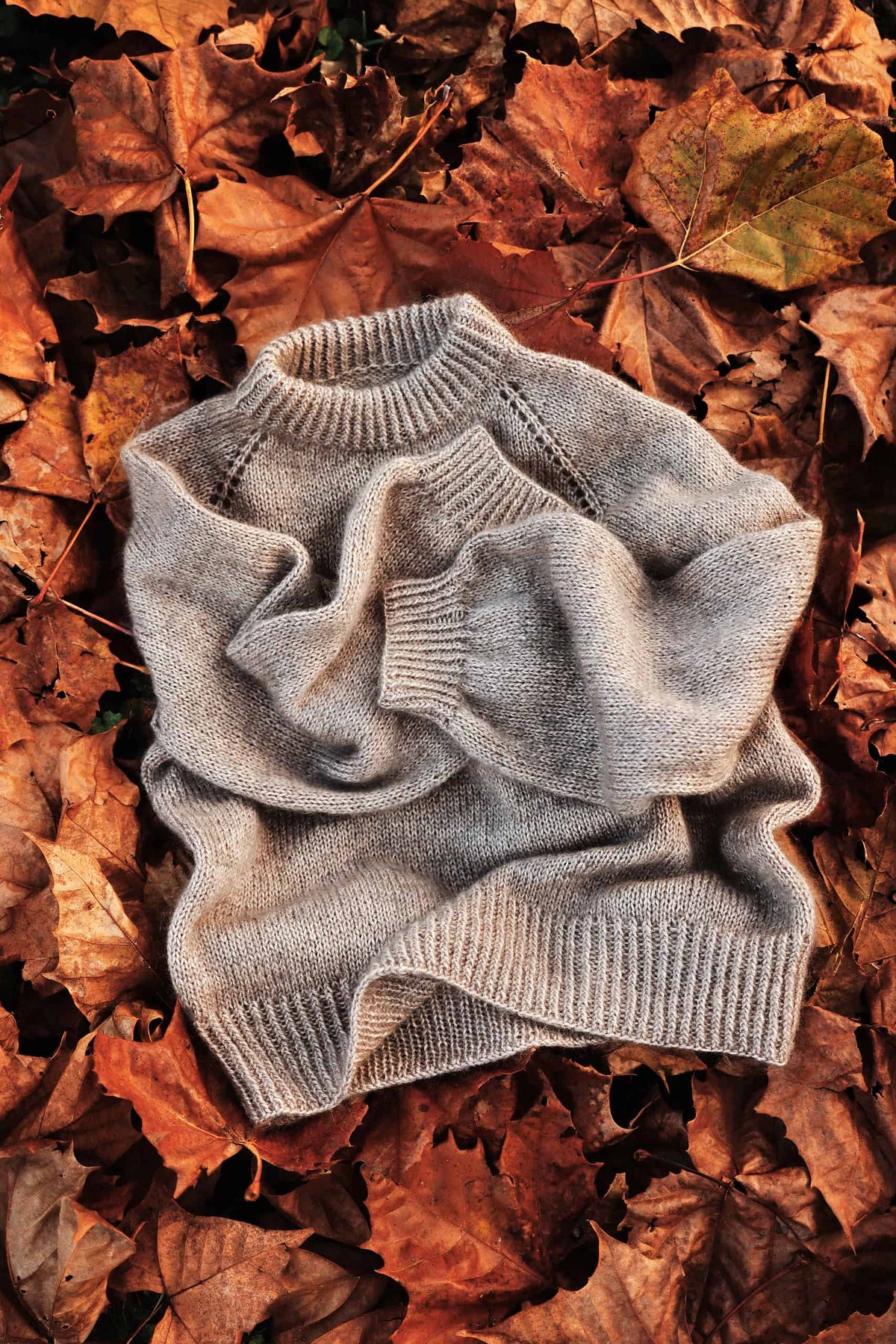 Close-up of delicate eyelet lace raglan detail on Café Sweater knitting pattern