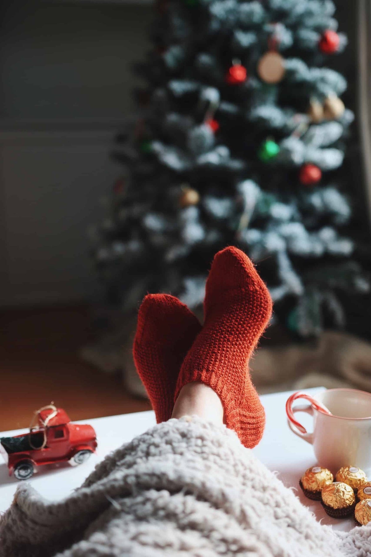 Cozy red shortie socks knitting pattern by Darling Jadore on rustic wood