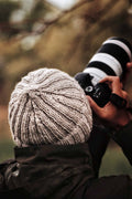 Classic ribbed beanie knitting pattern with double brim worn outdoors in winter
