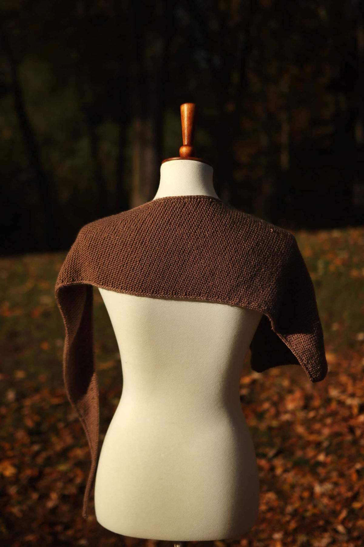 Small scarf knitting pattern showing boomerang shape and effortless styling