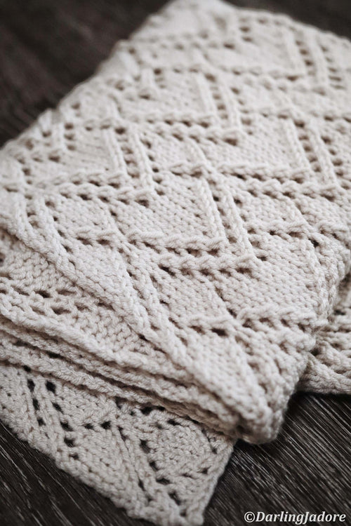 Elegant cream lace scarf draped showing full length and geometric lace detail