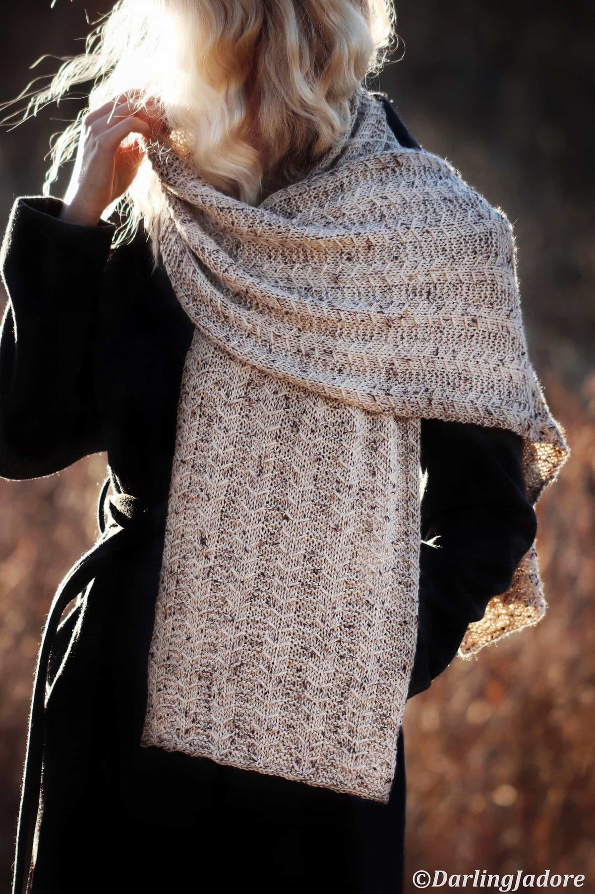 Textured geometric scarf knitting pattern draped elegantly showing intricate stitch detail