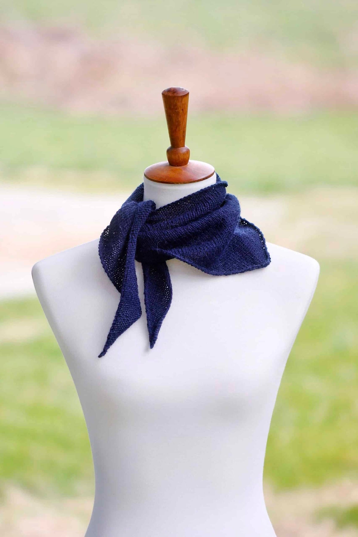 Delicate triangle kerchief scarf knitting pattern styled around neck showing lightweight drape
