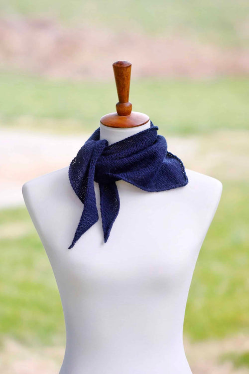 Delicate triangle kerchief scarf knitting pattern styled around neck showing lightweight drape