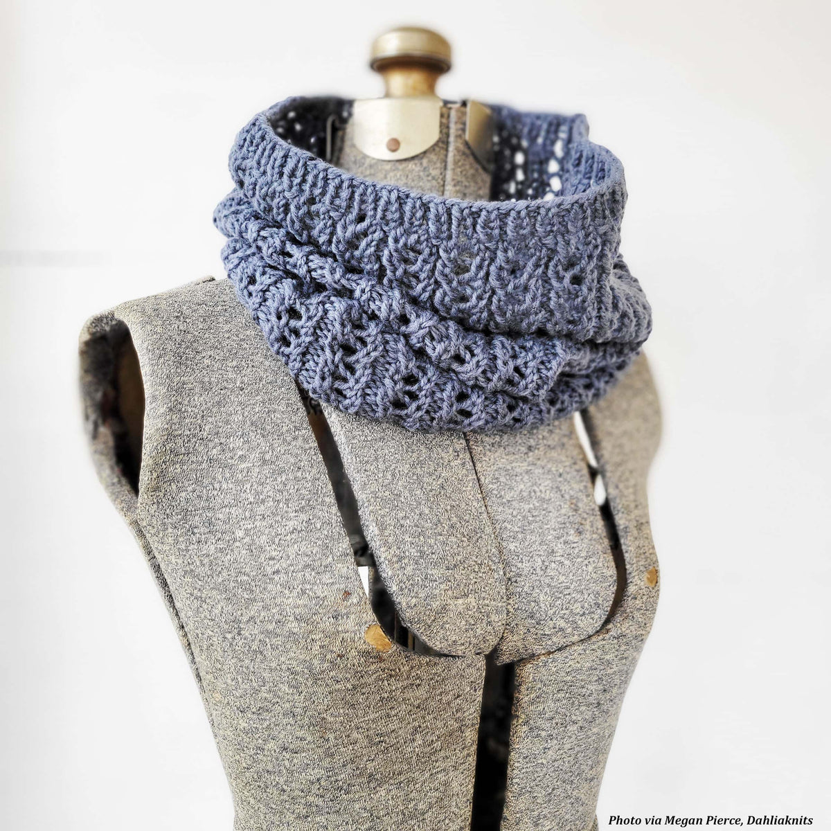Woman wearing cream lace cowl scarf knitted with The Snowfall Cowl pattern in natural light
