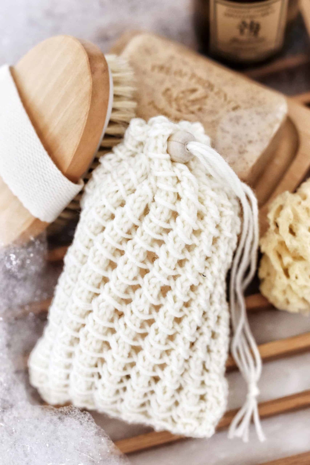 The Sudsy Soap Saver knitting pattern showing airy lace stitch detail and drawstring design